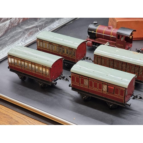 119 - Hornby O Gauge: a group of 6 vintage locomotives (3 boxed); together with 8 carriages.... 