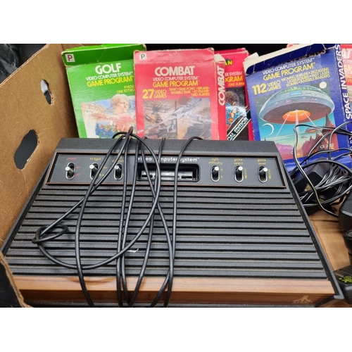 12 - Atari: a vintage 2600 console; together with controllers and five related boxed games.... 