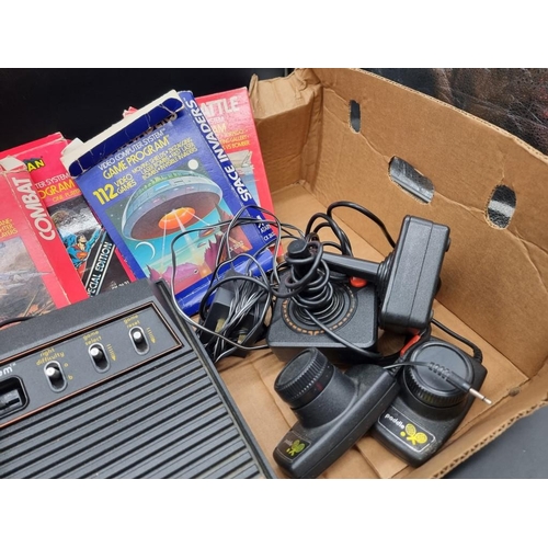 12 - Atari: a vintage 2600 console; together with controllers and five related boxed games.... 