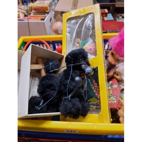 121 - Pelham Puppet: a black Poodle; and a Tyrolean Girl, both in original boxes; together with a col... 