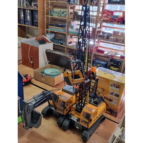 143 - Hobby Engine: Excavator and Crawler Crane, both battery operated remote controlled, with controllers... 