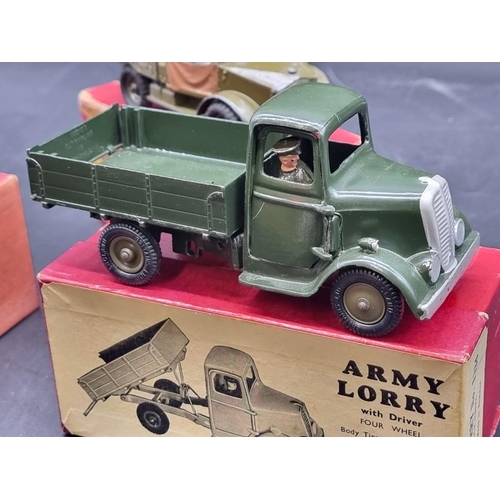 41 - Britains: three vintage military vehicles, comprising: Army Lorry No.1334 (x2); a Beetle Lorry No.18... 