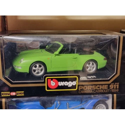 69 - Burago: four boxed Burago cars. to include a green Porsche 911.