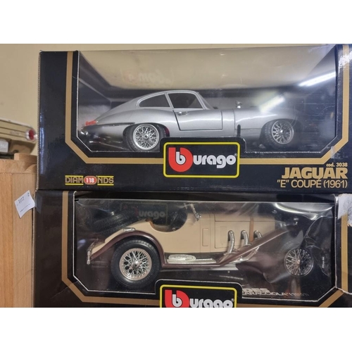 80 - Burago: four boxed models, to include a silver E Type.