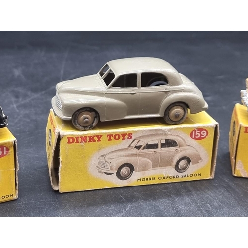 83 - Dinky: three vintage boxed vehicles, comprising: Morris Oxford Saloon No.159; Studebaker Land C... 