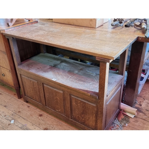 1096 - An oak panelled monk's bench, 104cm wide.  