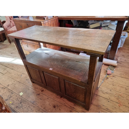 1096 - An oak panelled monk's bench, 104cm wide.  