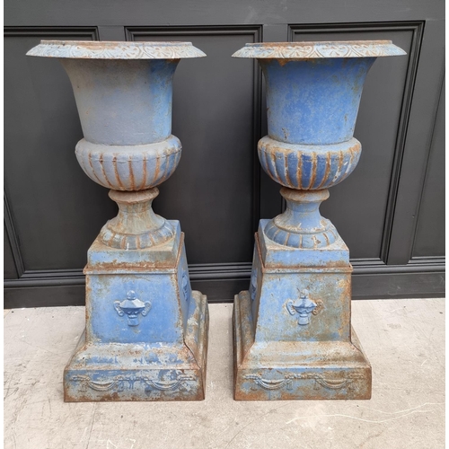 1203 - A large pair of blue painted cast iron Campana urns and stands, 113cm high.