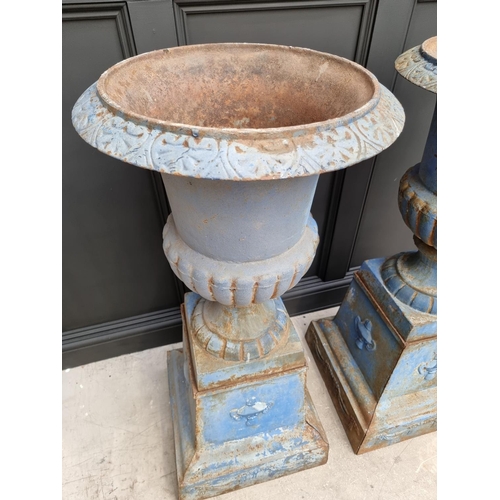 1203 - A large pair of blue painted cast iron Campana urns and stands, 113cm high.