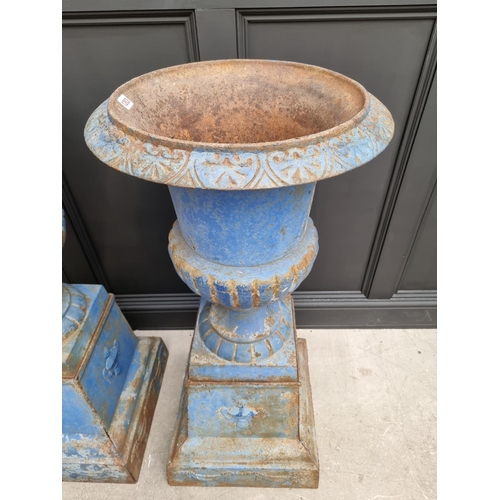 1203 - A large pair of blue painted cast iron Campana urns and stands, 113cm high.