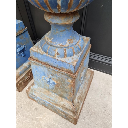 1203 - A large pair of blue painted cast iron Campana urns and stands, 113cm high.