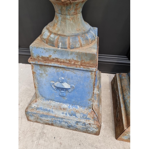 1203 - A large pair of blue painted cast iron Campana urns and stands, 113cm high.