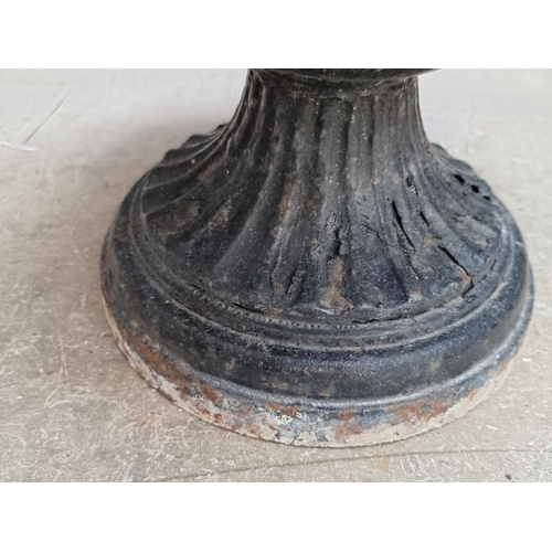 1205 - A pair of black painted cast iron Campana urns, 33cm high.