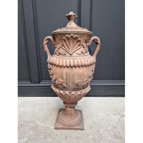 1207 - A large red composition stone twin handled urn, 84cm high, on associated pedestal, total height 132c... 