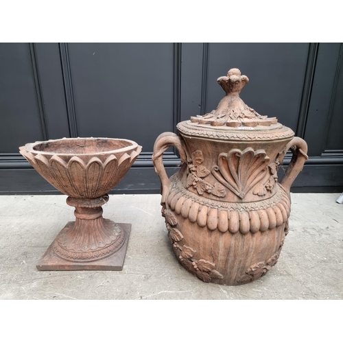 1207 - A large red composition stone twin handled urn, 84cm high, on associated pedestal, total height 132c... 