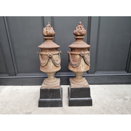 1208 - A pair of Neo-Classical style cast iron gate pier finials, 64cm high, (one lacking swag).... 