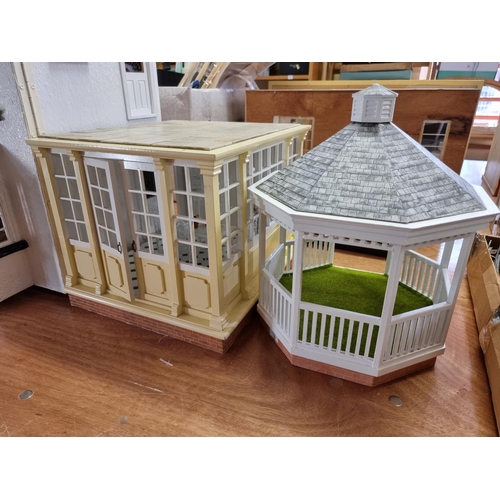 150 - Dolls House: a large two storey wooden doll house, 89cm wide x 62cm high; together with garage and c... 