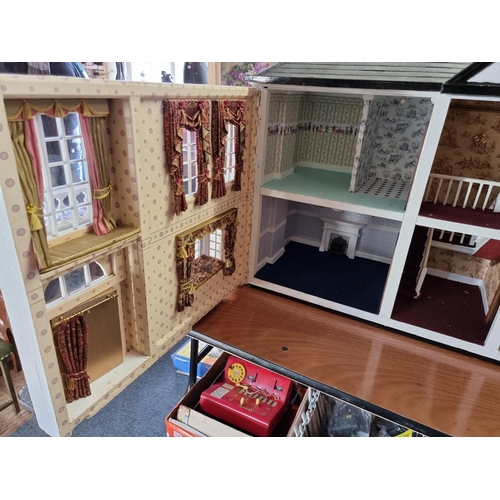 150 - Dolls House: a large two storey wooden doll house, 89cm wide x 62cm high; together with garage and c... 