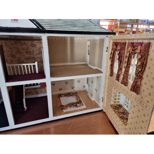 150 - Dolls House: a large two storey wooden doll house, 89cm wide x 62cm high; together with garage and c... 