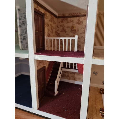 150 - Dolls House: a large two storey wooden doll house, 89cm wide x 62cm high; together with garage and c... 