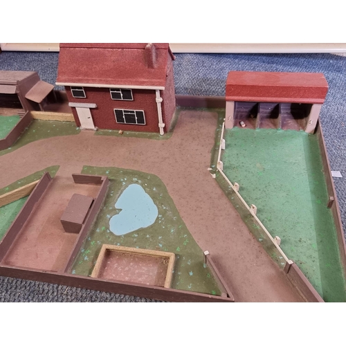 156 - Farmyard: a wooden farmyard play base with building and a quantity of animals and related items.... 