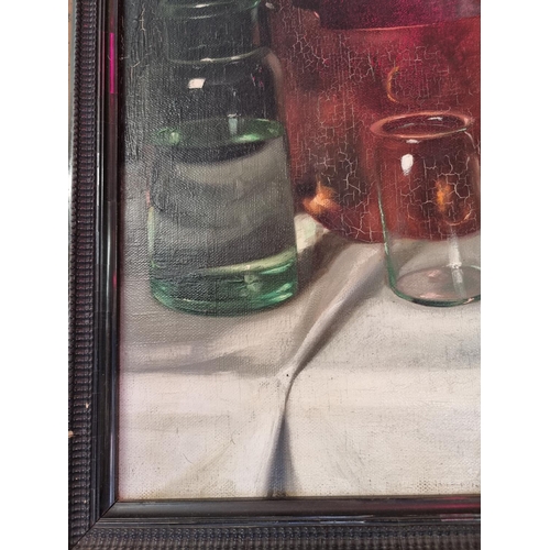 1570 - Arpad Romek, still life of glass bottles and other items, signed, oil on canvas, 54 x 67cm.... 