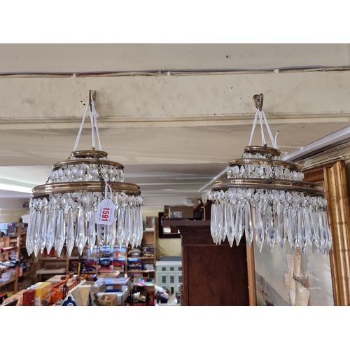 1591 - A pair of faceted glass drop three tier chandeliers, 22.5cm diameter.  