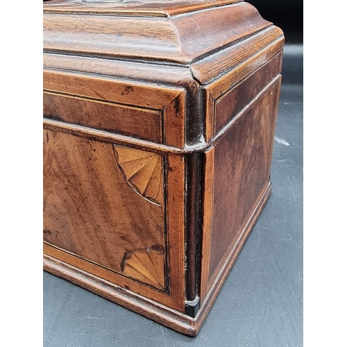 1054 - A George III mahogany and inlaid tea caddy, 26.5cm wide.