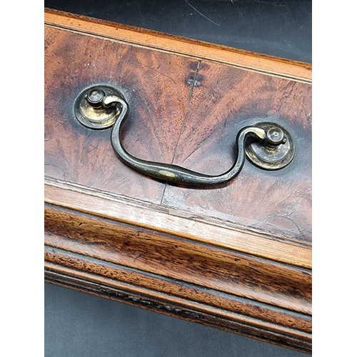 1054 - A George III mahogany and inlaid tea caddy, 26.5cm wide.