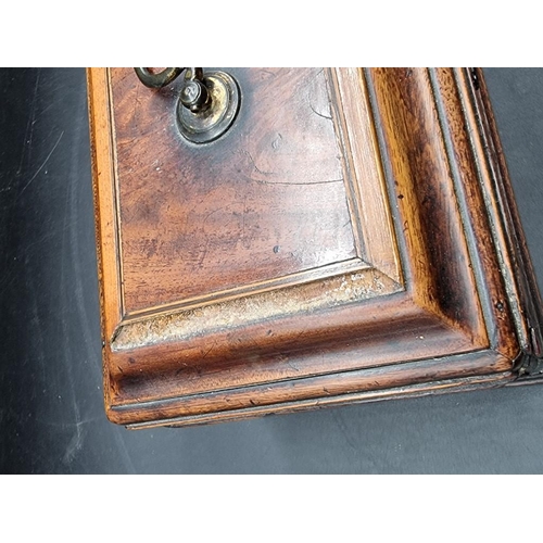 1054 - A George III mahogany and inlaid tea caddy, 26.5cm wide.