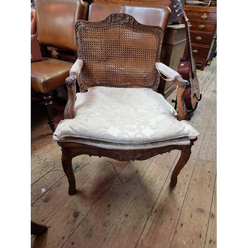 1091 - An antique French walnut and cane fauteuil, in Louis XV style.