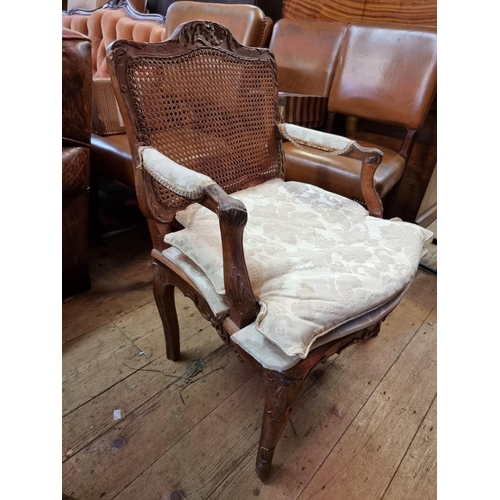 1091 - An antique French walnut and cane fauteuil, in Louis XV style.