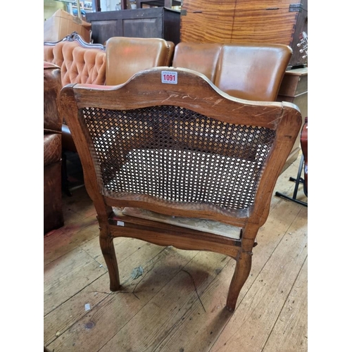 1091 - An antique French walnut and cane fauteuil, in Louis XV style.