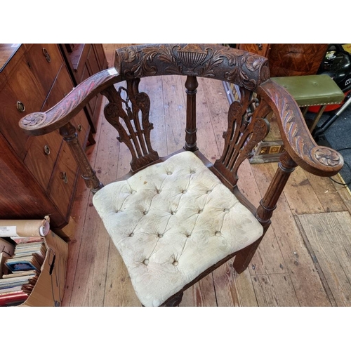 1093 - A George III carved oak corner elbow chair; together with a folding hardwood cake stand. (2)... 