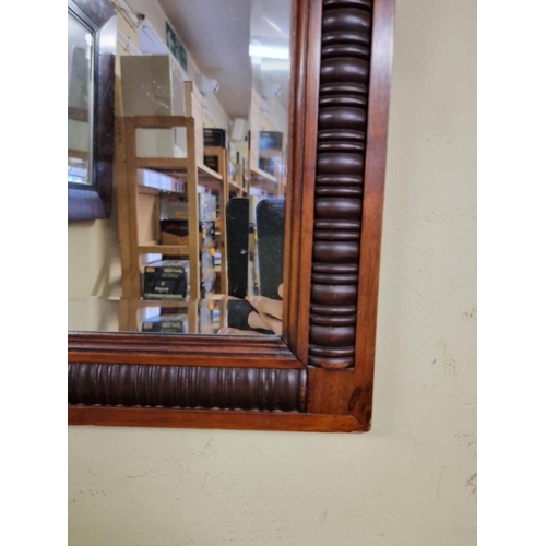 1112 - An Edwardian carved walnut framed rectangular wall mirror, with bevelled plate, 82.5 x 61.5cm.... 