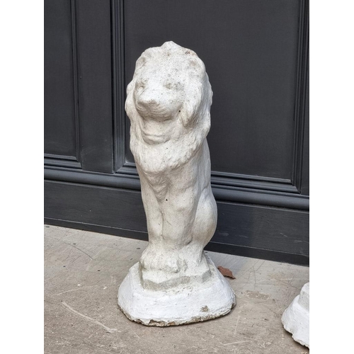 1206 - A pair of white painted composition stone lion gate pier finials, 56cm high.