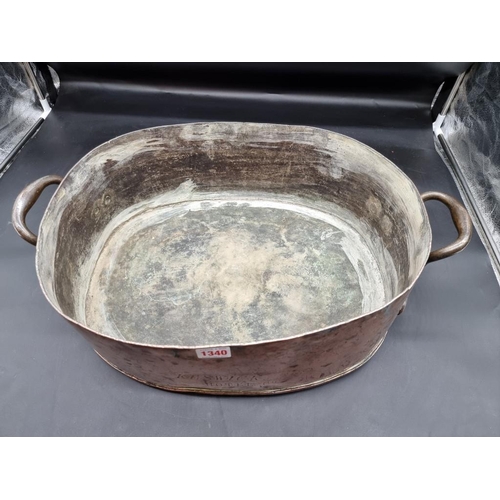 1340 - A large Victorian copper twin handled pan or kettle, inscribed 'Keswick Hotel Co', 57cm wide.... 