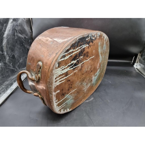 1340 - A large Victorian copper twin handled pan or kettle, inscribed 'Keswick Hotel Co', 57cm wide.... 