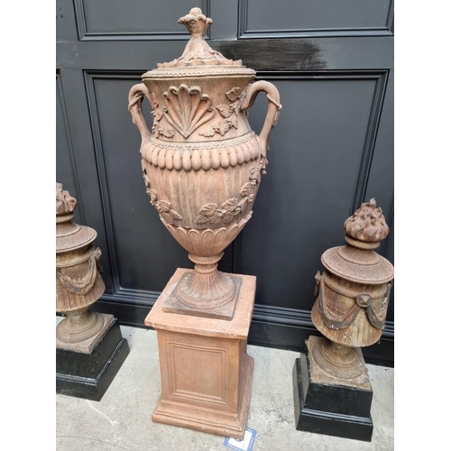 1207 - A large red composition stone twin handled urn, 84cm high, on associated pedestal, total height 132c... 