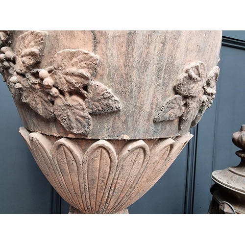 1207 - A large red composition stone twin handled urn, 84cm high, on associated pedestal, total height 132c... 