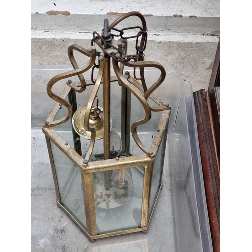 1194 - A set of three brass hexagonal ceiling lanterns, 40cm high.