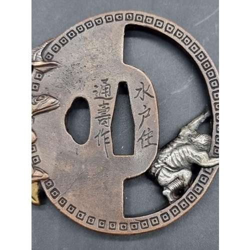 1518 - A Japanese bronze tsuba, possibly Edo, with silvered and gilt highlights, decorated with a standing ... 