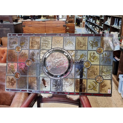 1339 - A stained and leaded glass rectangular panel, 93.5 x 53cm, (cracks to three small panels).... 