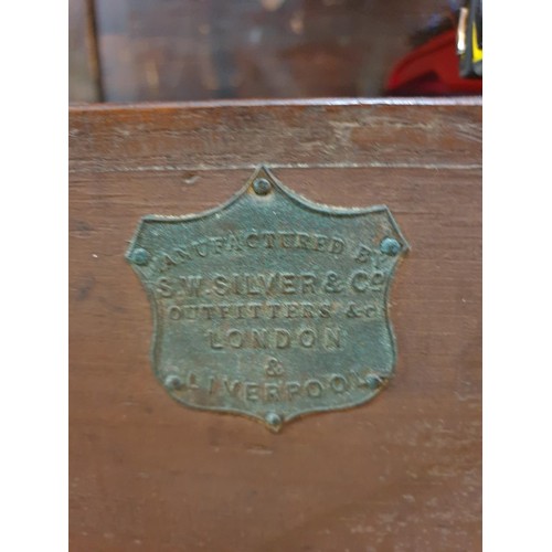 1077 - An antique teak and brass bound campaign chest, labelled 'Manufactured by S W Silver & Co,...Lon... 