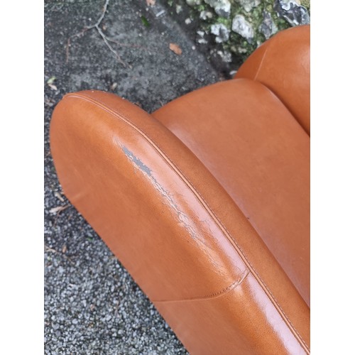 1152 - A modern leatherette chair and stool, (surface wear).