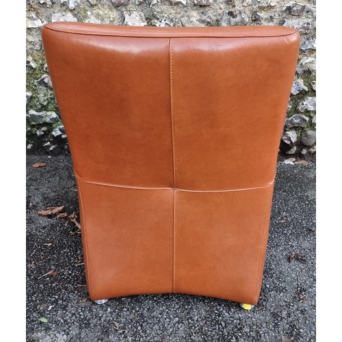 1152 - A modern leatherette chair and stool, (surface wear).