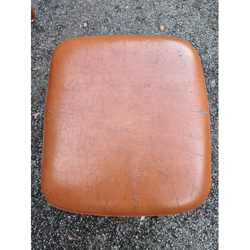 1152 - A modern leatherette chair and stool, (surface wear).