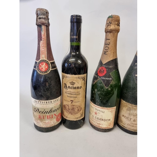 104 - A mixed group of wine and champagne, to include two old bottles of Moet & Chandon NV. (8)... 