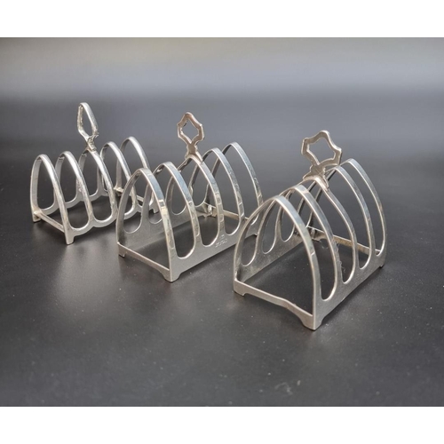 305 - A pair of silver five bar toast racks, by Viners, Sheffield 1935, 7.5cm long; together with another ... 