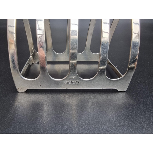 305 - A pair of silver five bar toast racks, by Viners, Sheffield 1935, 7.5cm long; together with another ... 